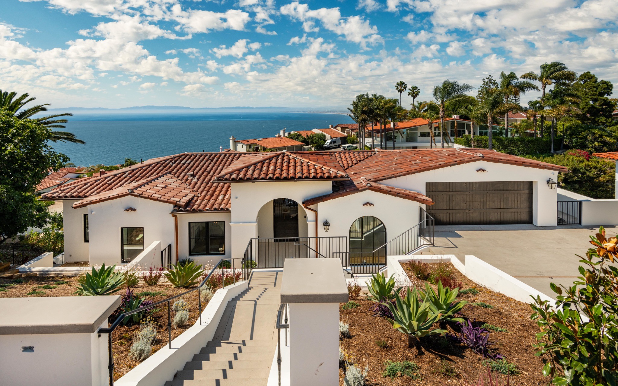 Via Del Monte home with tiled roof, arched entry and ocean views